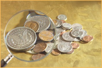 Magnifying glass focused on pile of silver and copper American coins